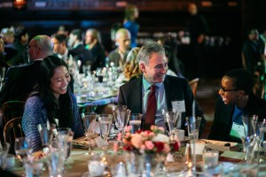 Three people sitting at a dinner table