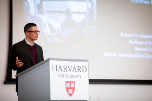 Roberto Gonzales gives presentation at podium.