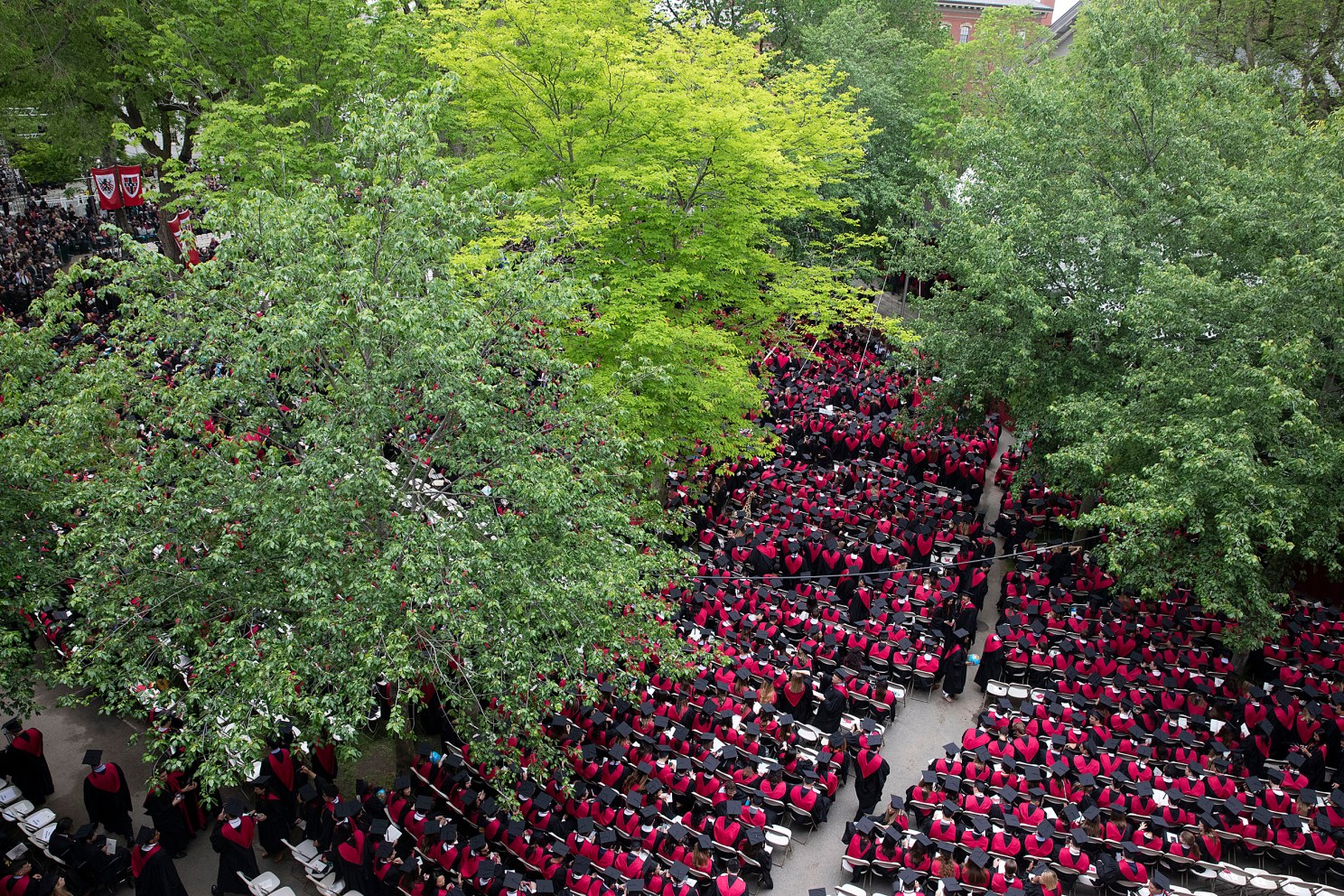 A birds eye view of a sea of Business School Graduates in red robes during Commencement morning exercises