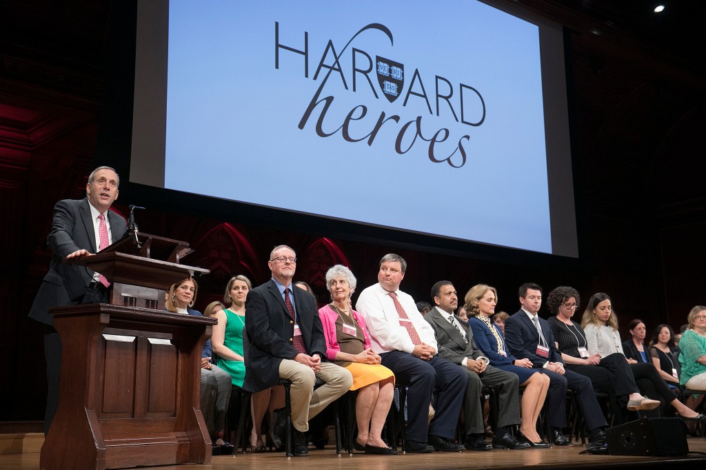 Larry Bacow at the podium onstage in Sanders Theater.