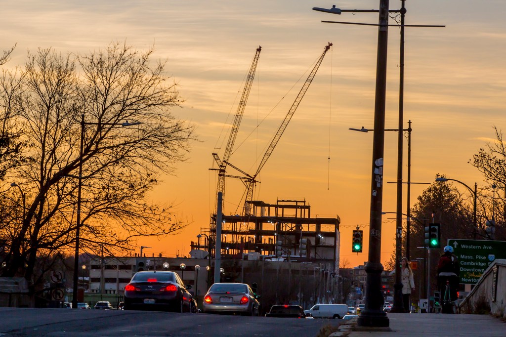 Building under construction in front of a sunset