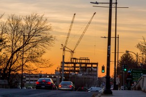 Building under construction in front of a sunset