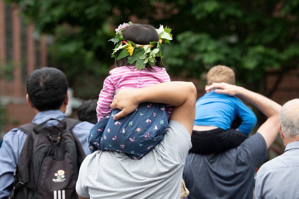 Child on parent's shoulders