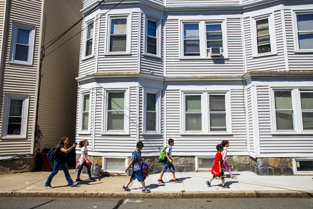 Children walking by a house