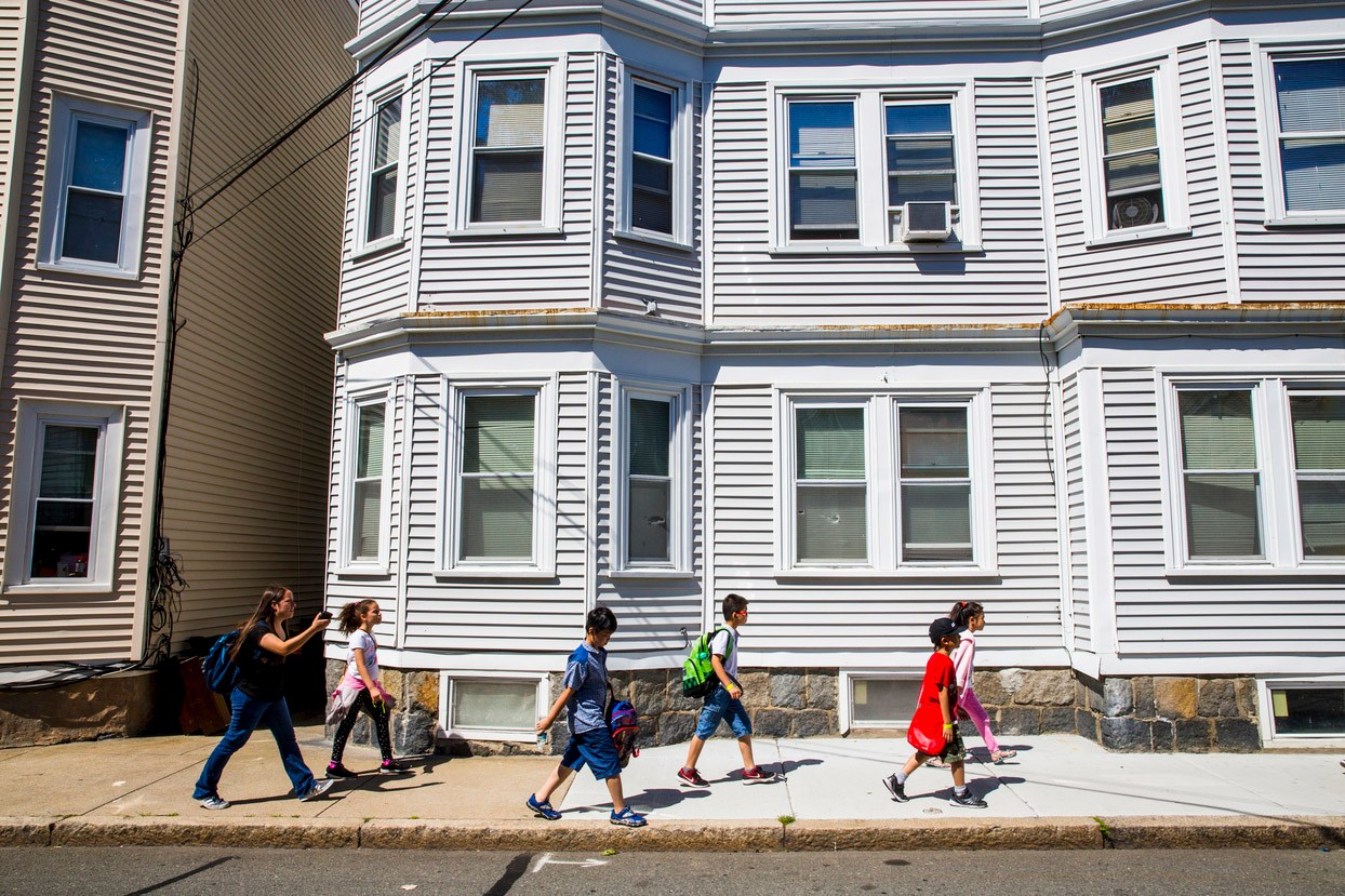 Children walking by a house