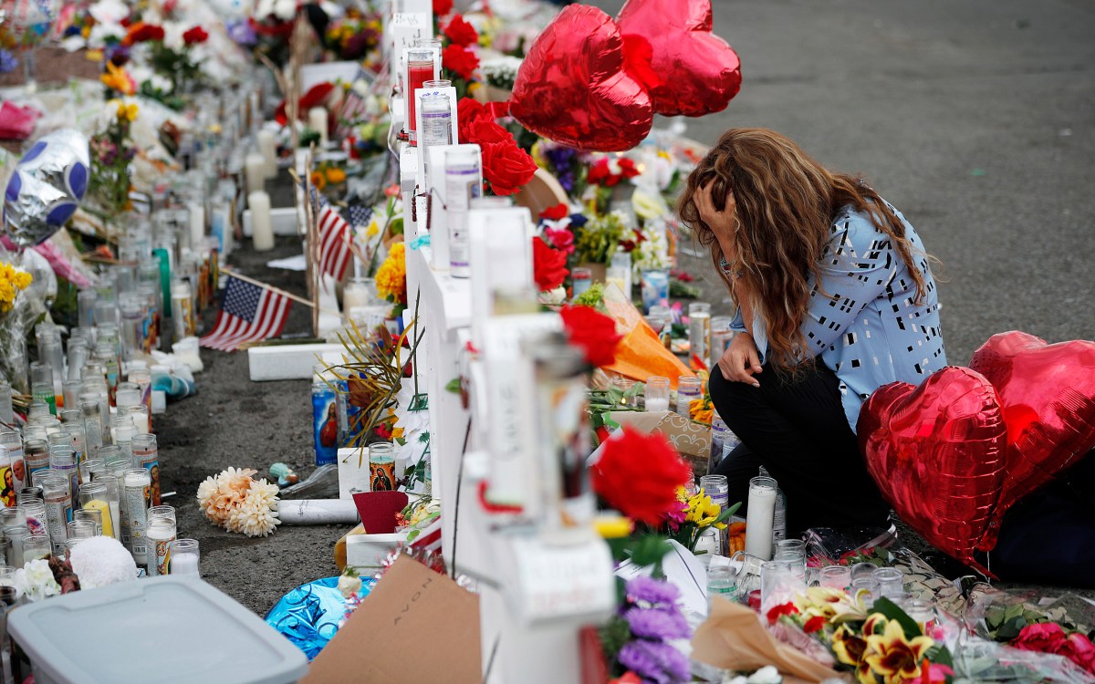 Woman mourns at memorial