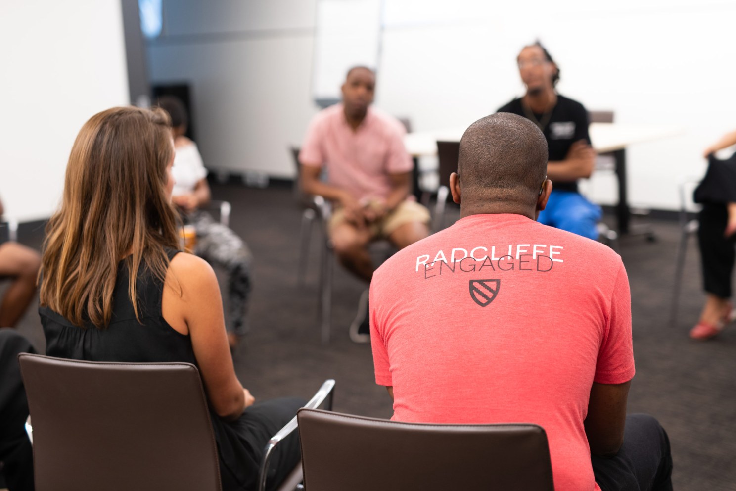 People sitting in a circle in chairs