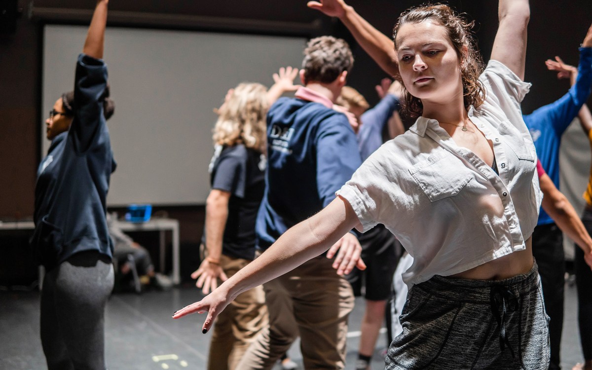 Performers rehearse choreography