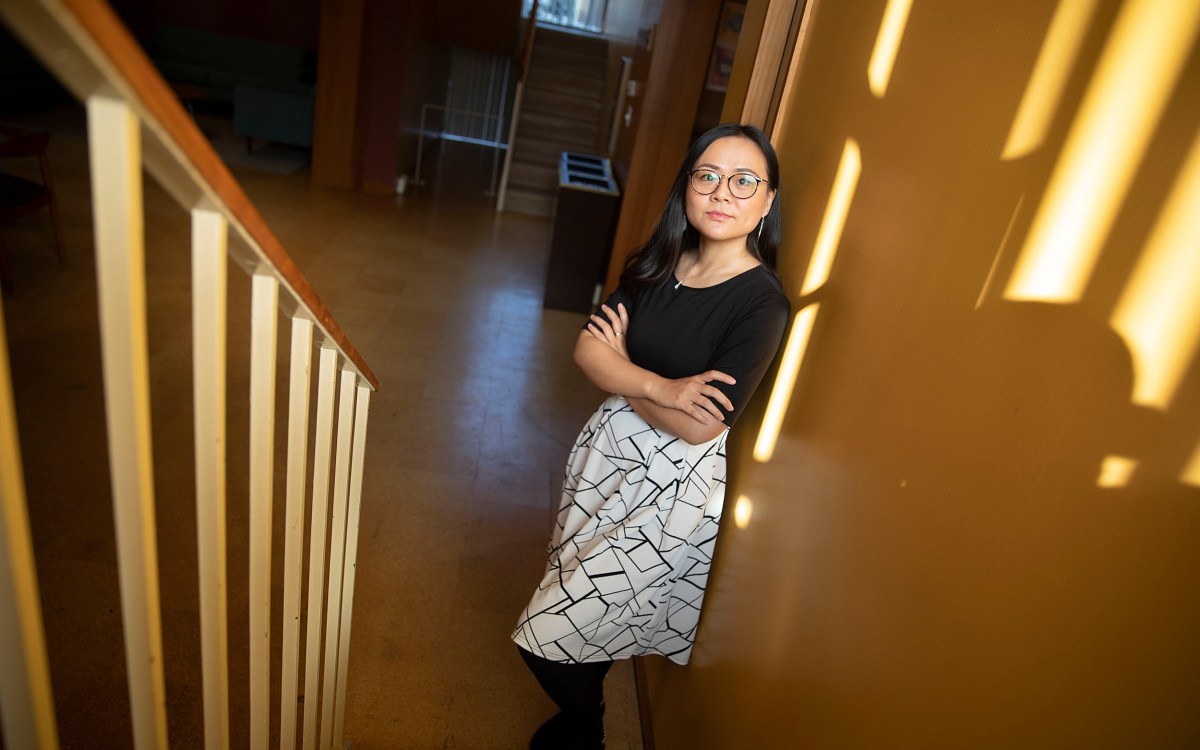 Asian woman standing in stairwell.