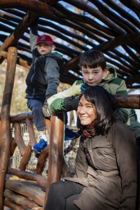 Joan Naviyuk Kane in a barn with her two sons