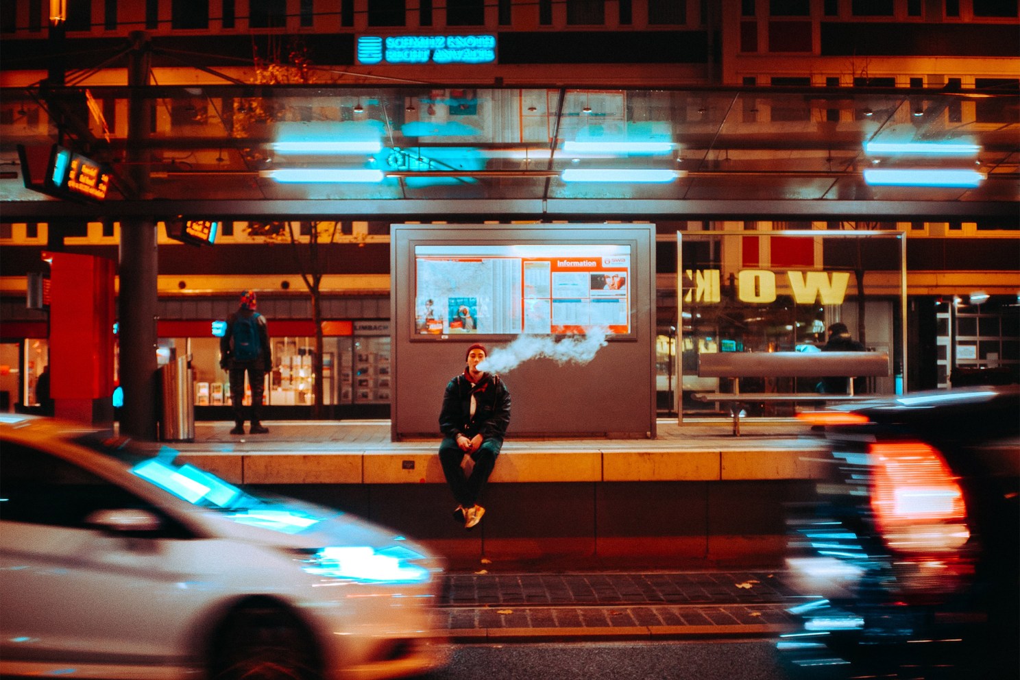 Man sitting on side of highway vaping.