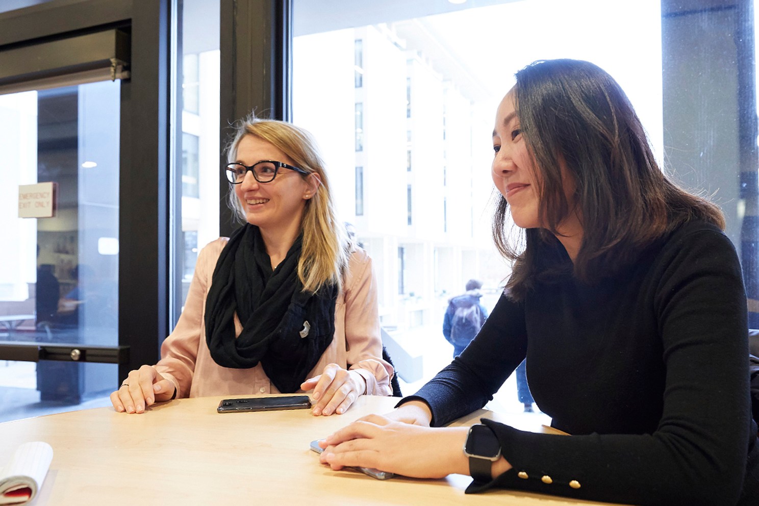 Two women sitting at a table.