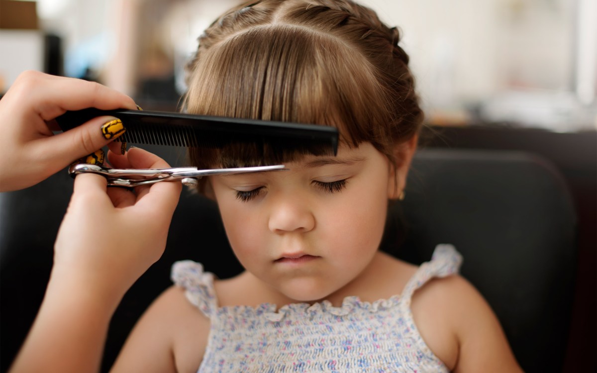 Little girl getting haircut.