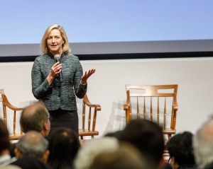 Woman speaking onstage.