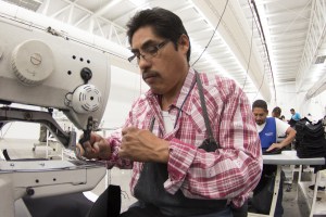 Man using sewing machine.