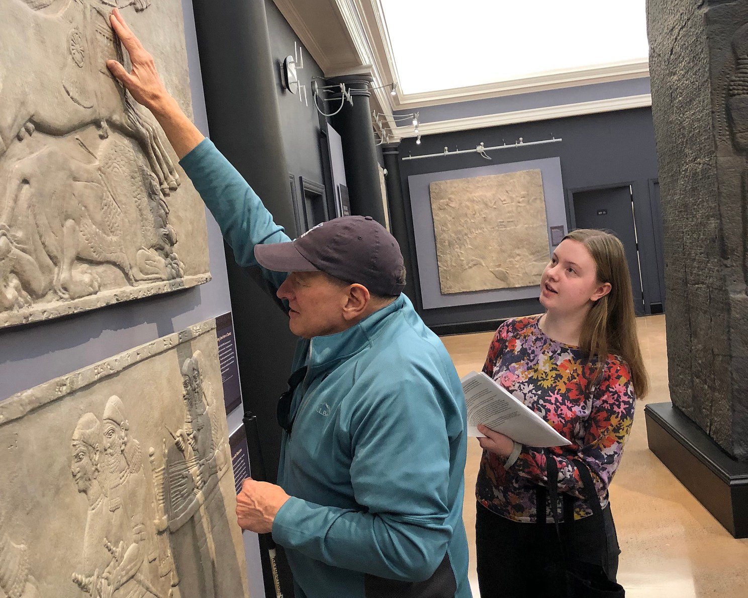 Visitor touches exhibit piece.