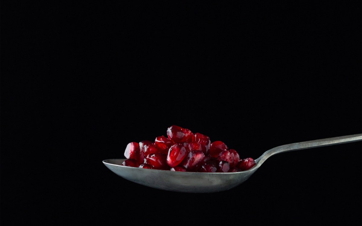 Spoon with pomogranate seeds.