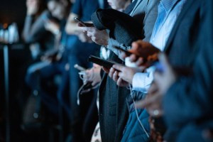 Crowd of people using cellphones.