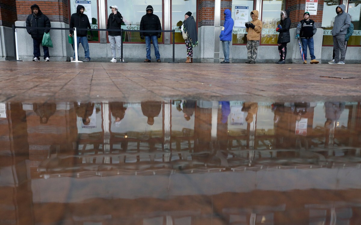 People standing in line but keeping their distance.