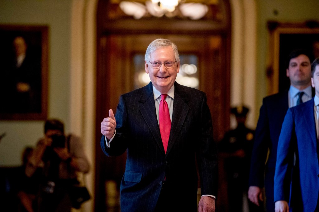 Senate Majority Leader Mitch McConnell gives a thumbs up