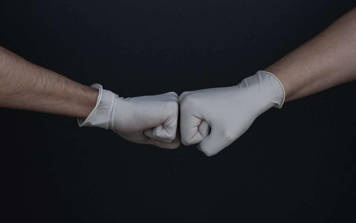 Fist bump wearing gloves.