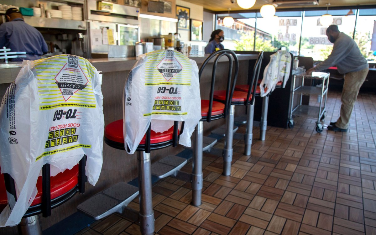 Customer picks up order in Waffle House.