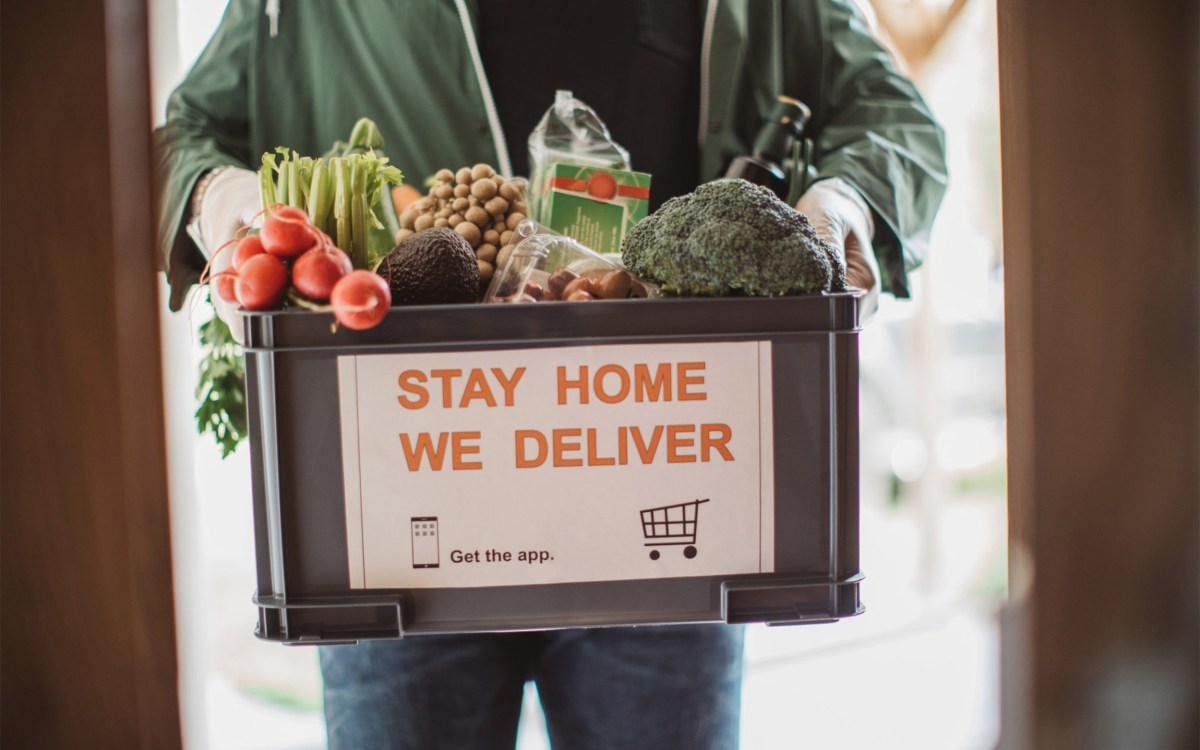 Man holding box of food.