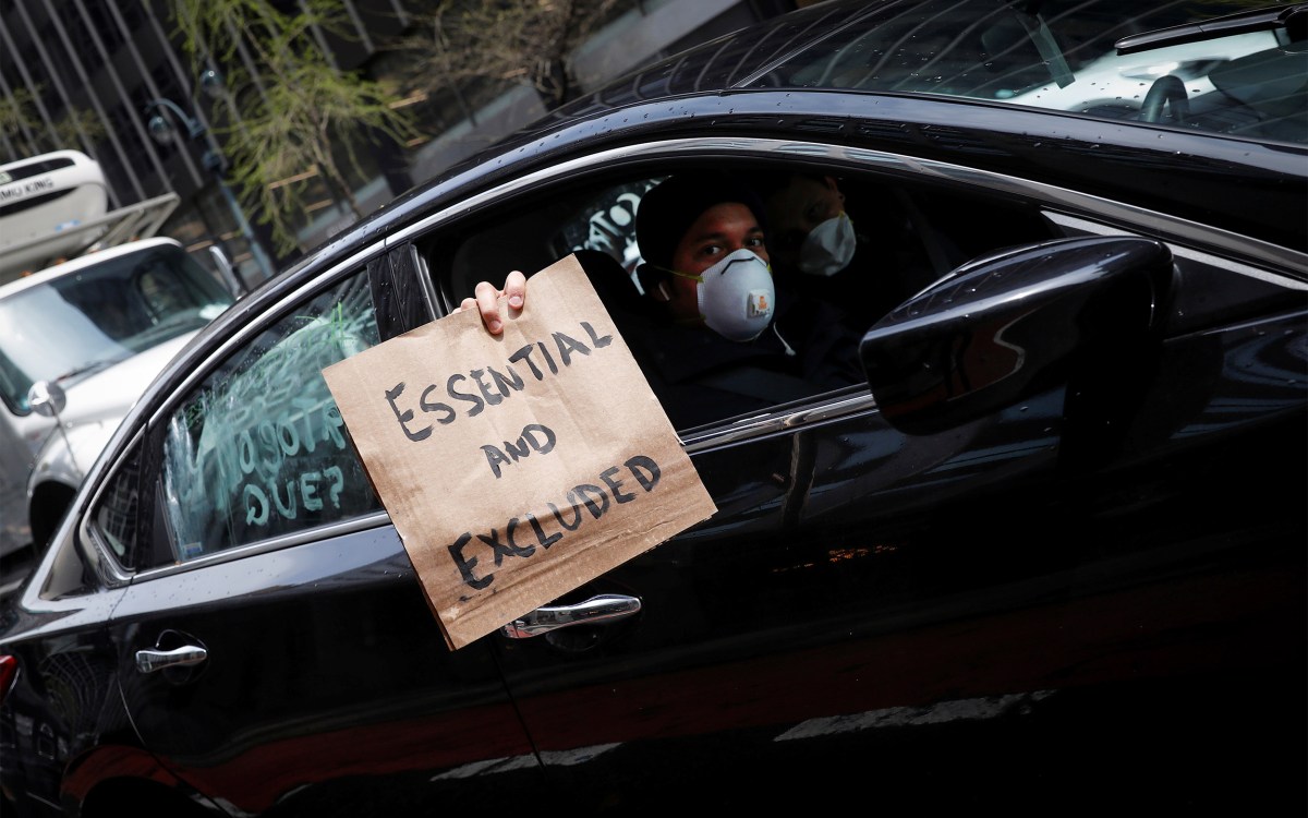 Man holding a protest sign from car.