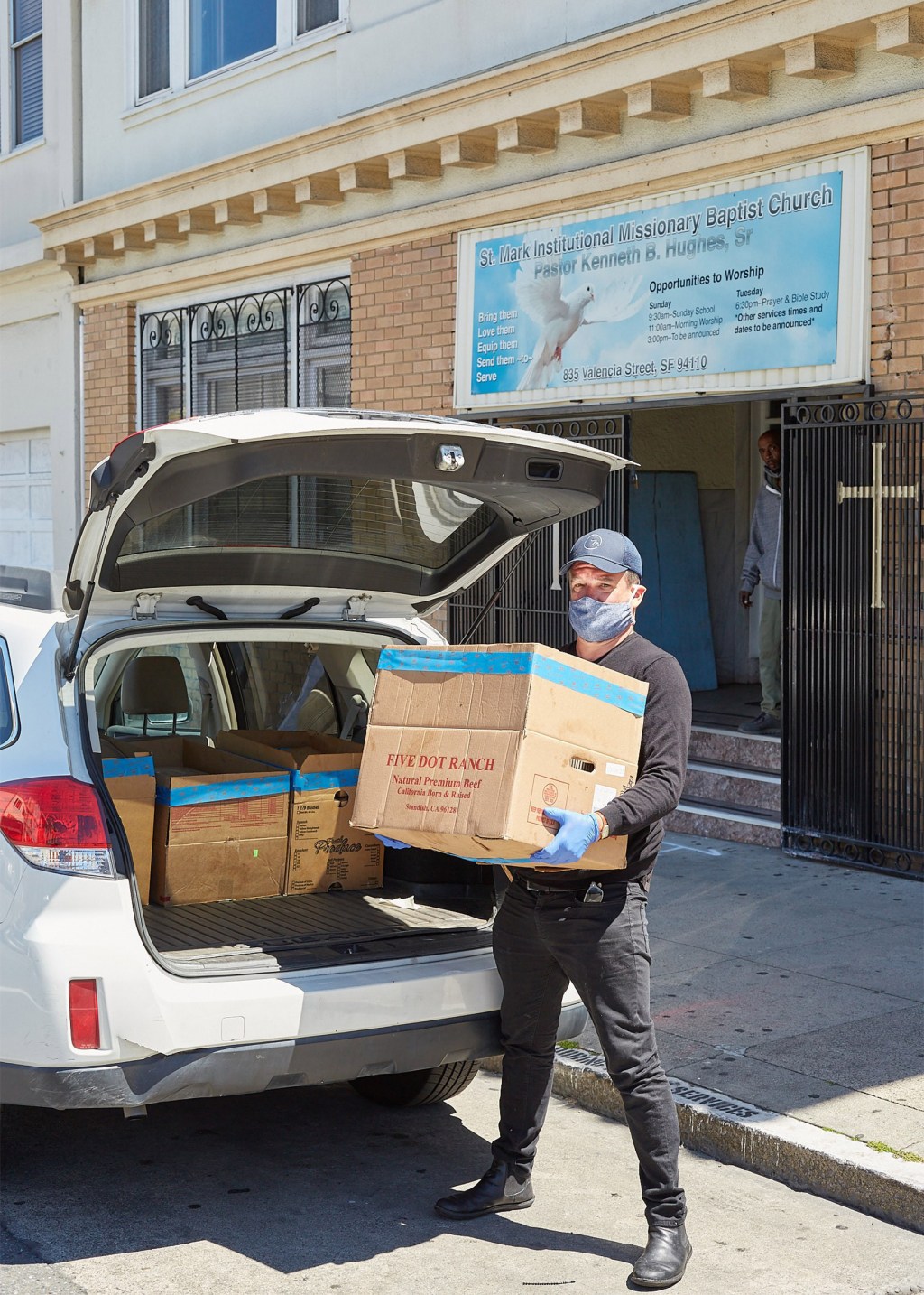 Loading boxes of food into a car.