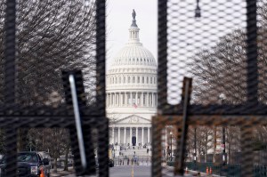 Capitol viewed through barricades.