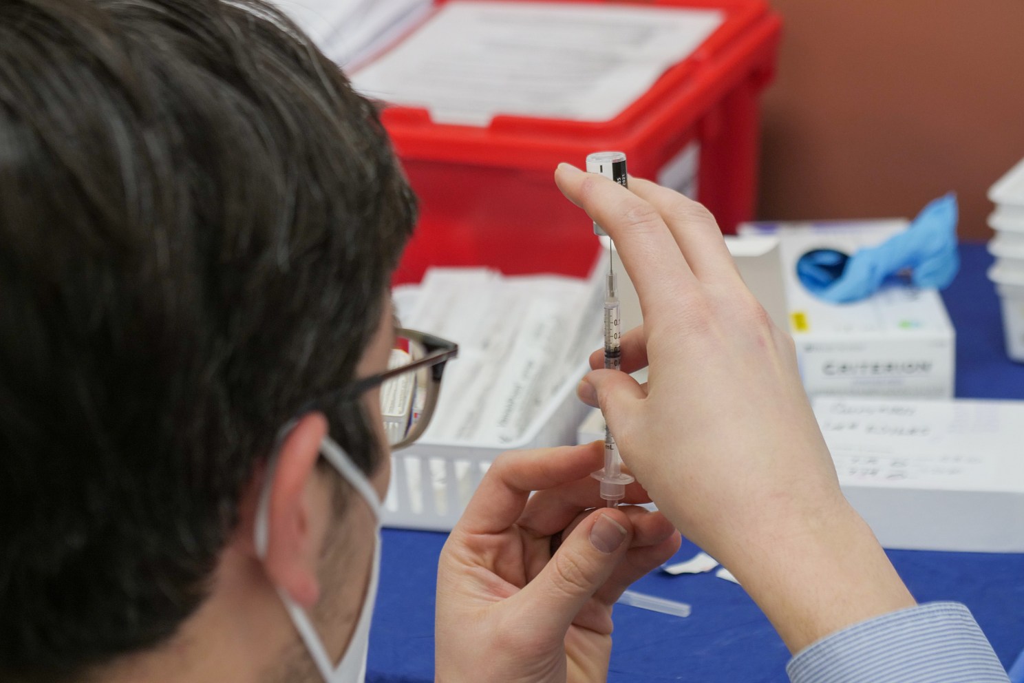 Pharmacist prepares vaccine.