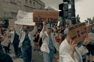 Doctors holding up signs at a protest.