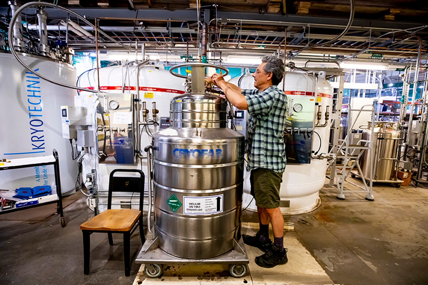 Markos Hankin fills helium tanks at the Helium Recovery Facility at Harvard.
