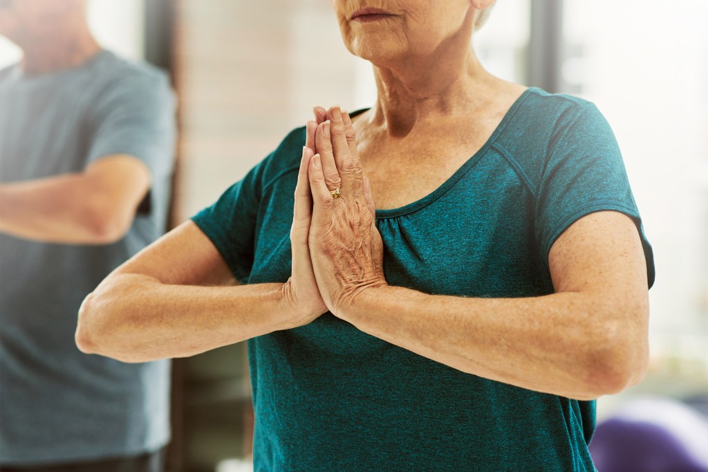 Older woman doing yoga.