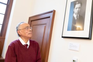 Spencer Jourdain looks up at portrait of father Edwin Bush Jourdain Jr.
