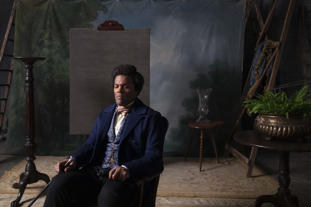 Frederick Douglass sits in photo studio chair in Isaac Julien's "Lessons of the Hour."