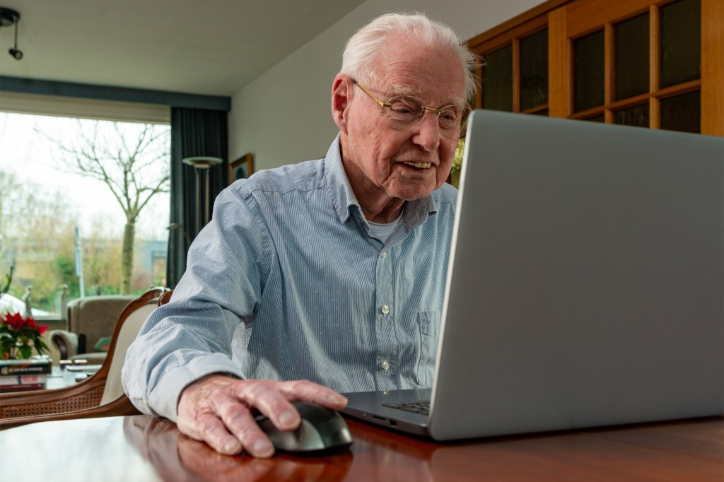 Elderly man with computer.