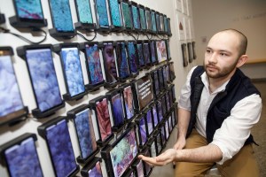 Wall of smart phones that stories were recorded on. as part o the exhibit.