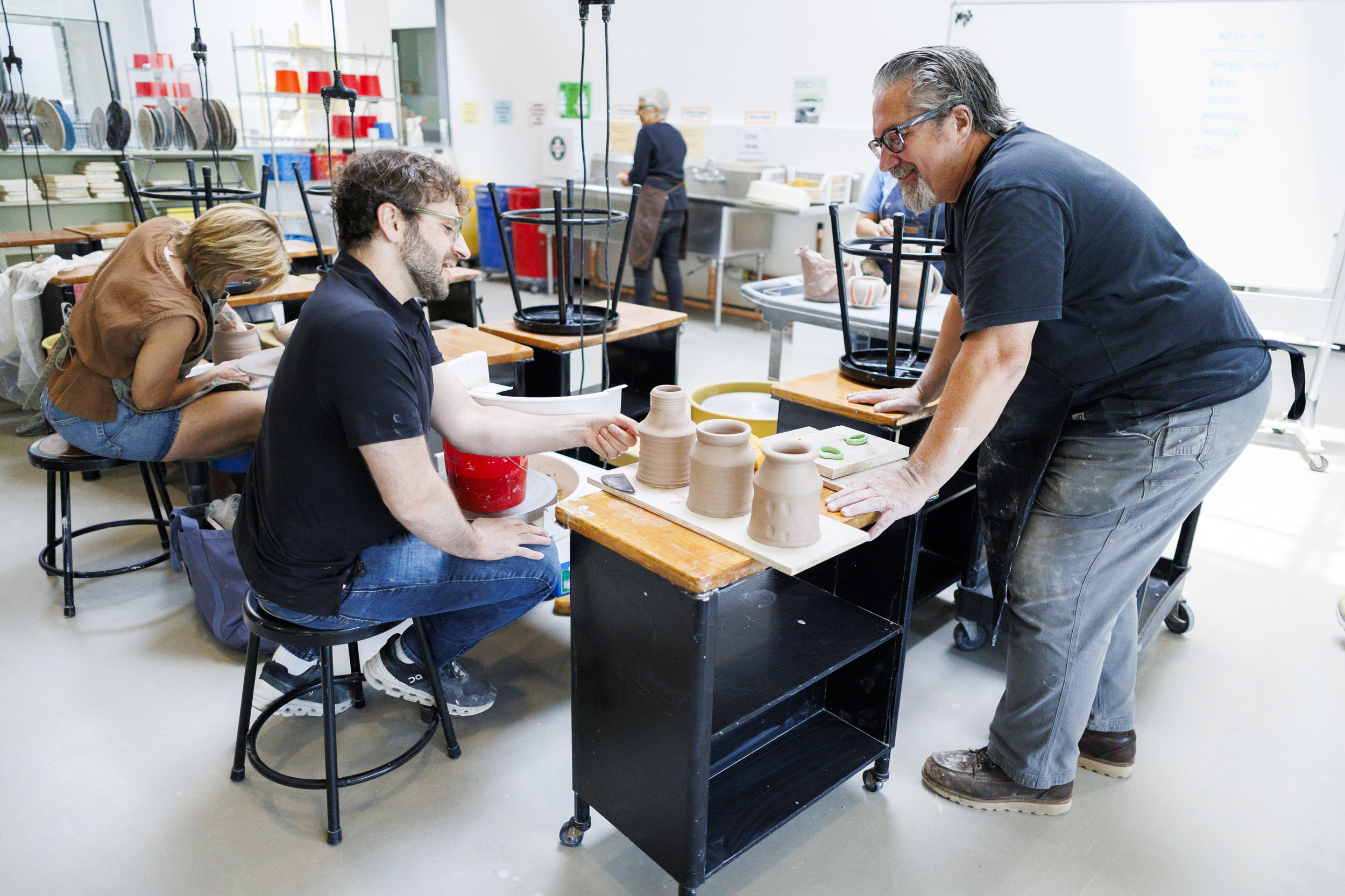 Gard (left) and Hubbard check in at the wheel during class.