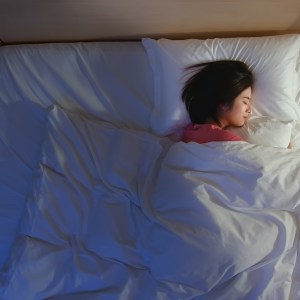 Woman sleeping in bed.