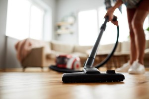 A person vacuums a home.