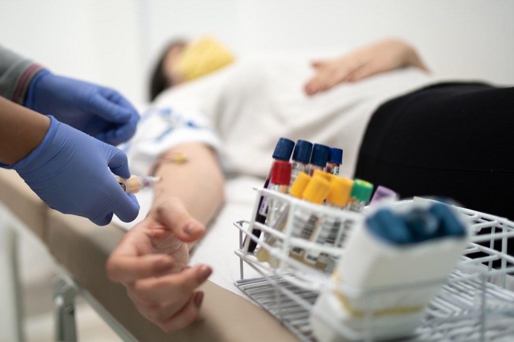 Nurse preparing patient to drawing blood sample.