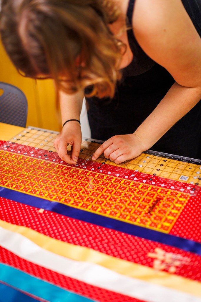 Lena Tinker ’25 (pictured) constructs a ribbon skirt. 