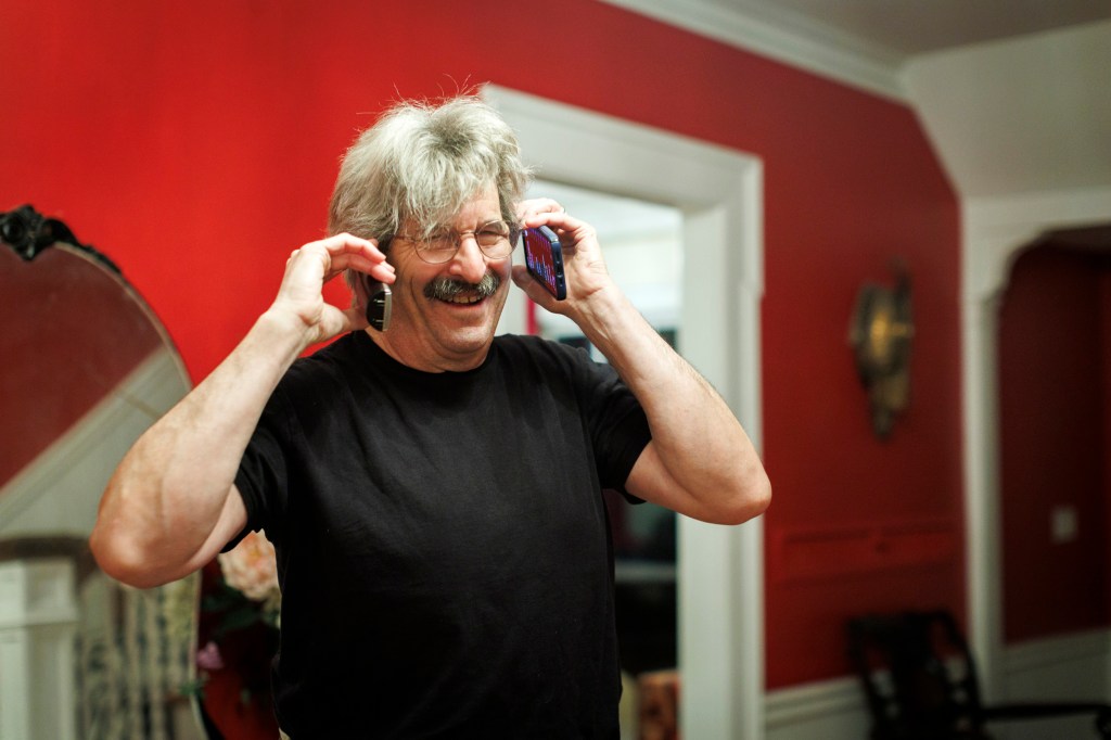 Gary Ruvkun talking into 2 cell phones after learning he'd won a Nobel.