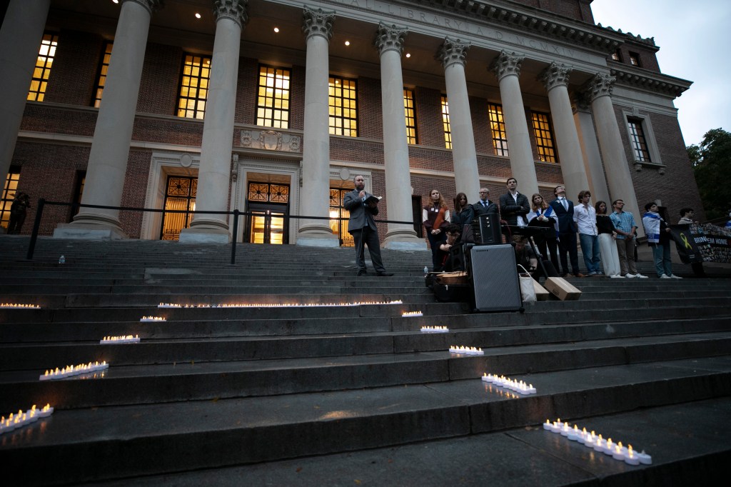 Rabbi Getzel Davis speaks during a vigil on the steps of Widener.