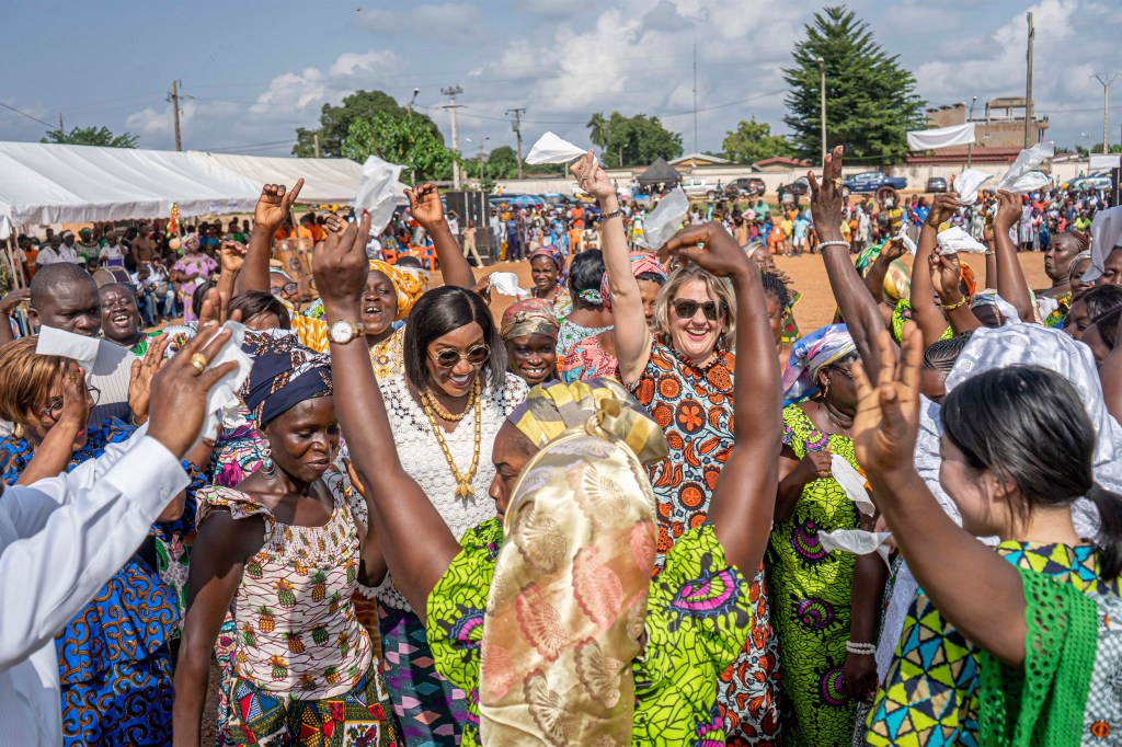 Mara Bolis (center) dances at a June event celebrating the mothers of La Mé, Côte d'Ivoire with Mayor Florence Achi (left) and HKS student Kotomi Odate (far right).