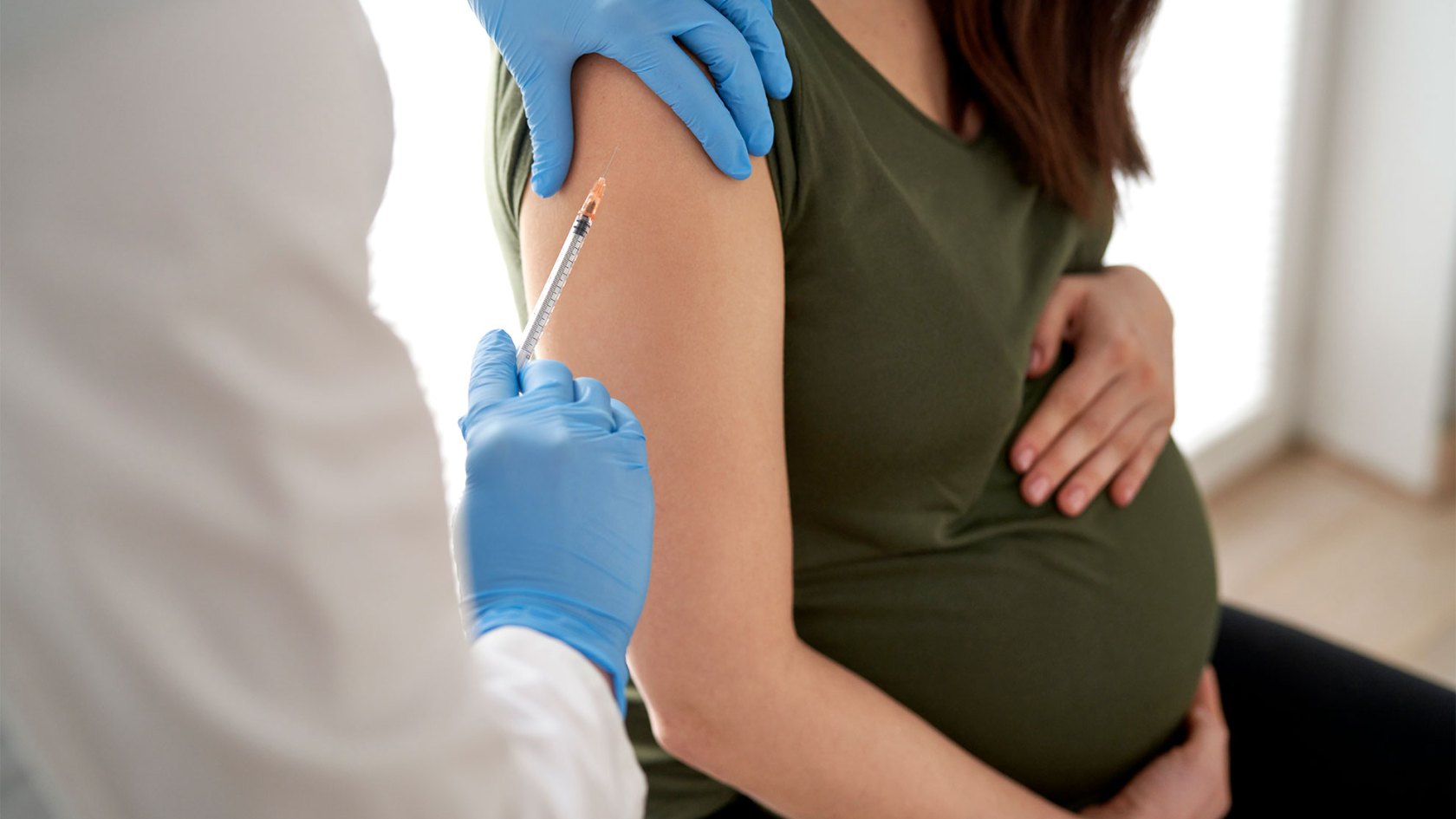 Pregnant woman getting a RSV vaccine.