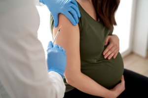 Pregnant woman getting a RSV vaccine.