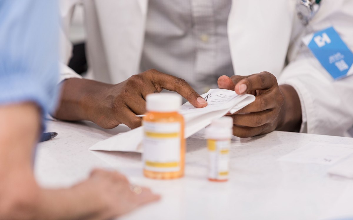 Pharmacist talking to a patient about prescription.