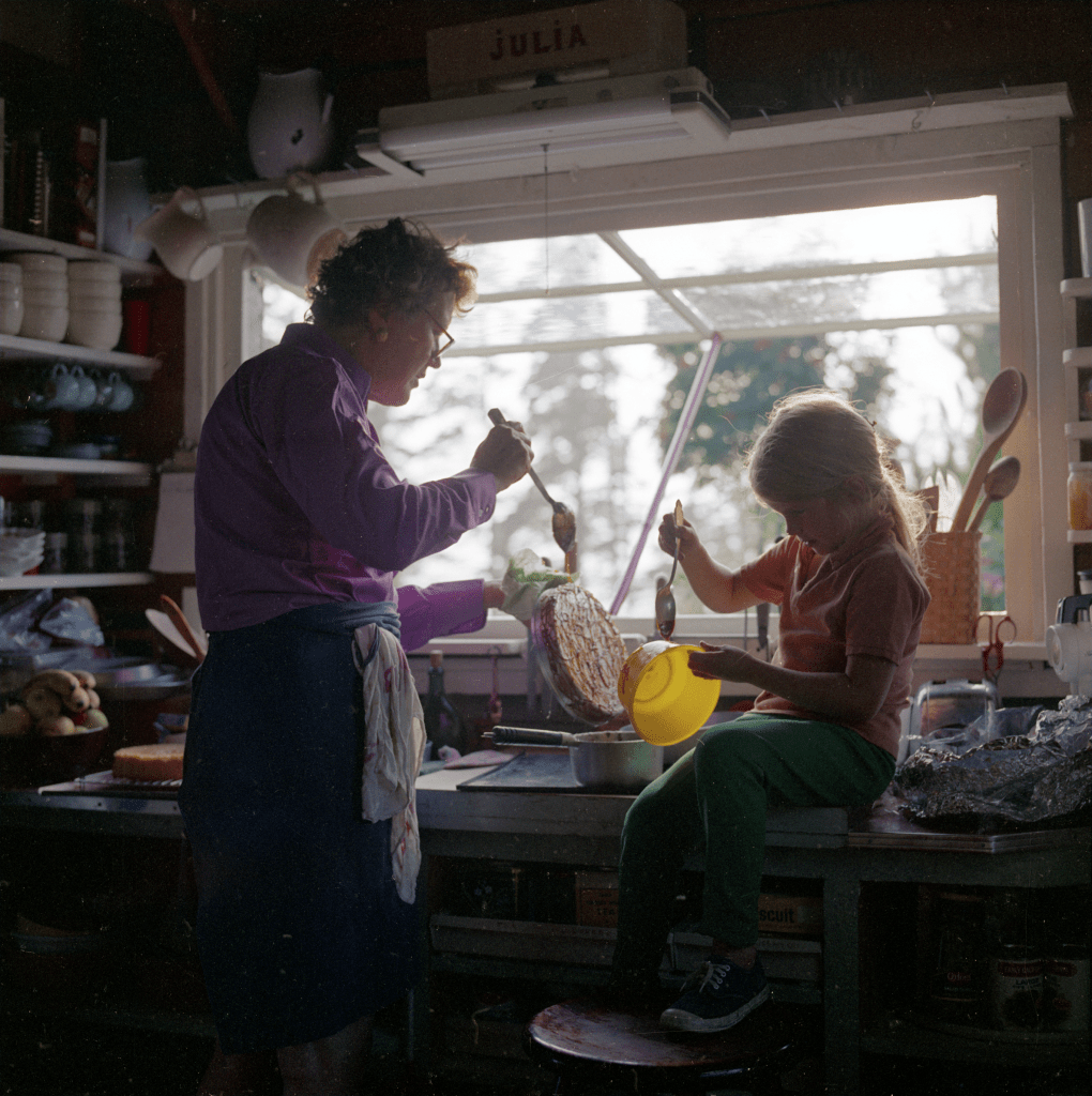 Julia Child demonstrating a frosting technique, with Merida.